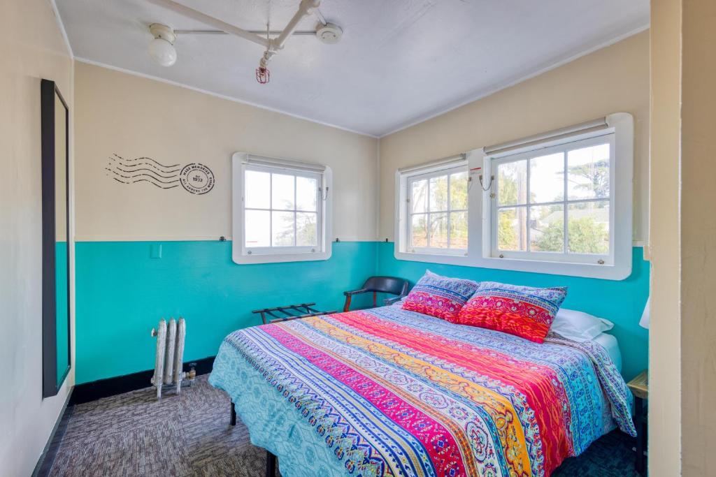a bedroom with a bed and two windows at HI San Francisco Fisherman's Wharf Hostel in San Francisco