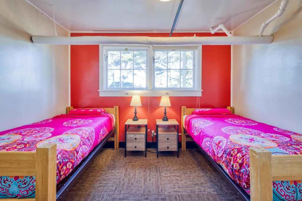 two beds in a room with red walls at HI San Francisco Fisherman's Wharf Hostel in San Francisco