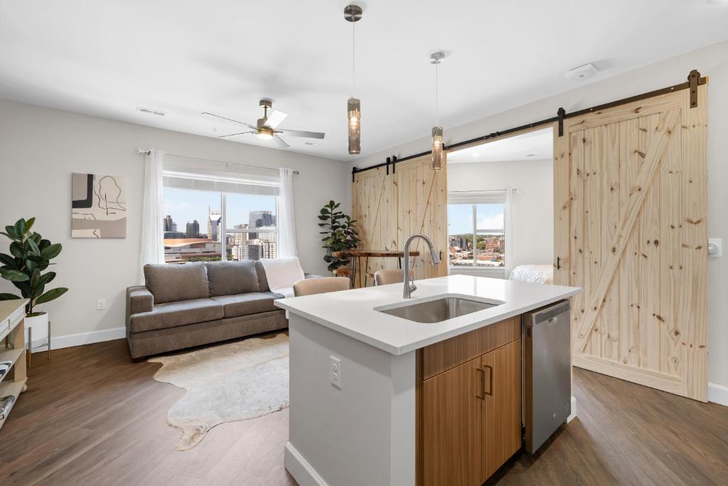 a kitchen with a sink and a sliding barn door at The Bel Air Suite The Gulch in Nashville
