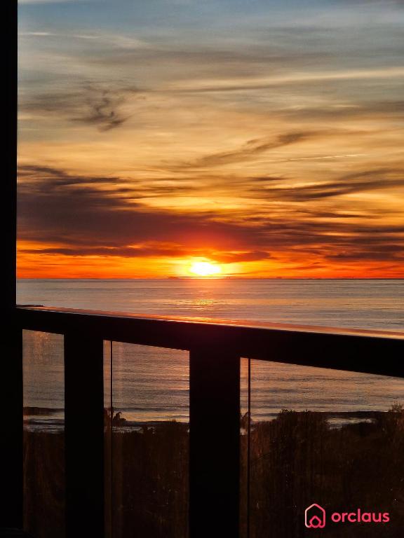 a sunset over the ocean with the sun in the sky at Una Mirada al Alba in Cabanes