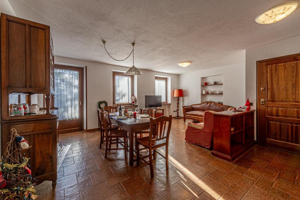 a living room with a table and a couch at CHALET PONTAL 3 - Relax e vista sulle montagne - COUR 0142 in Courmayeur