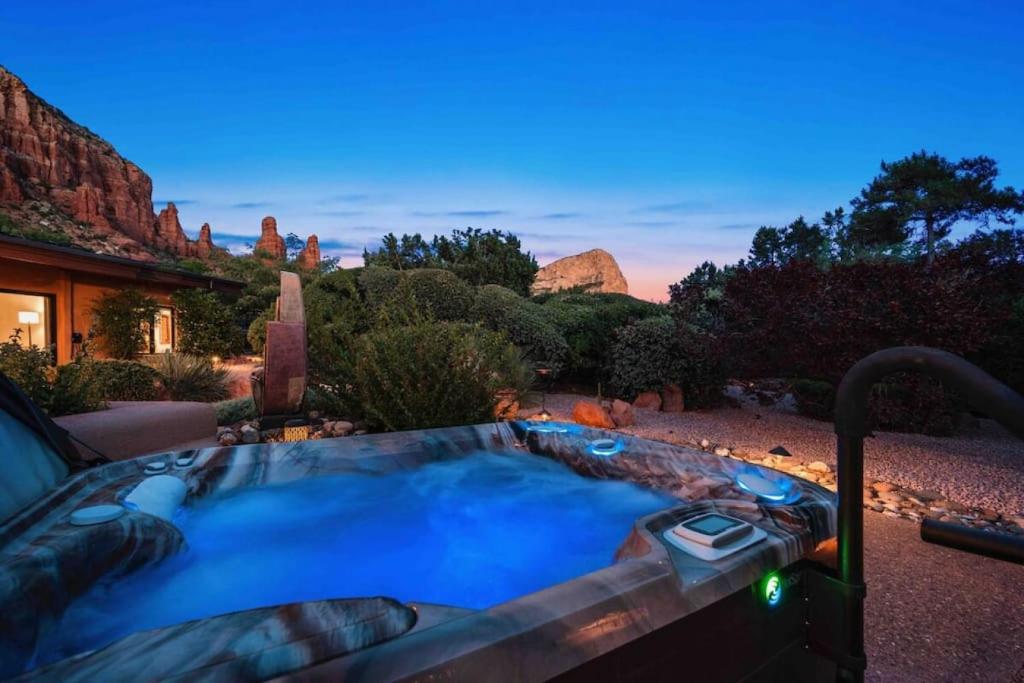 a hot tub in a yard with a view of a mountain at Chapel Vista Main House Red Rock Views and Hot Tub in Sedona
