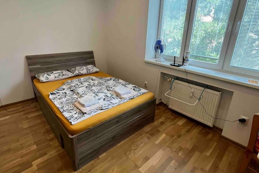 a bedroom with a bed in a room with a window at Brand new apartment in the heart of Bratislava in Bratislava