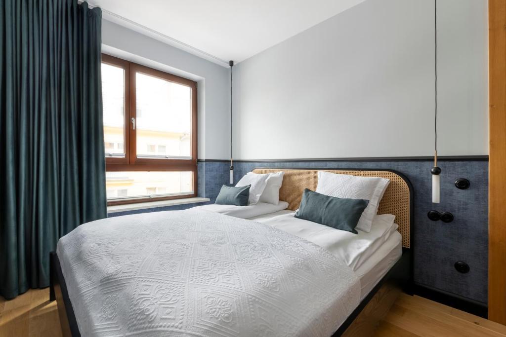 a bedroom with a large bed and a window at Homewell Apartments Czartoria- free parking in Poznań