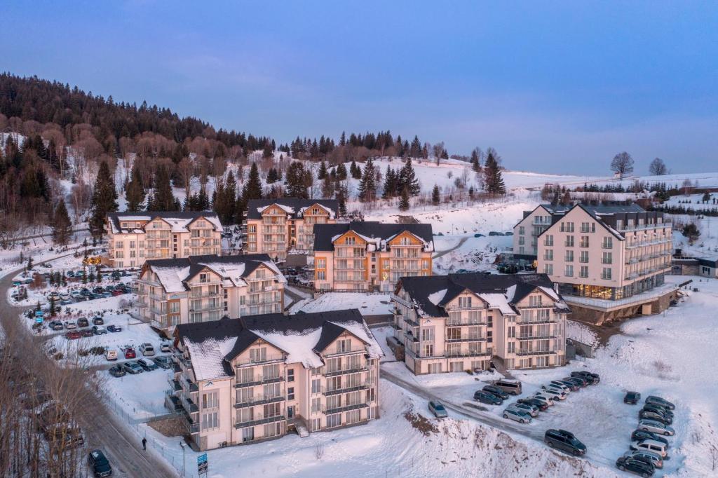 an aerial view of a resort in the snow at Apartament Czarna Góra S25 in Sienna