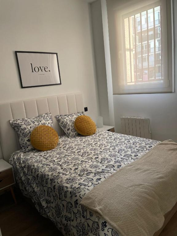 a bedroom with a bed with a love sign above it at Exyca Metropolitano in Madrid