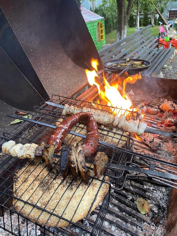 a bunch of sausages and meat on a grill at Guest house Shulc in Mizhhirya