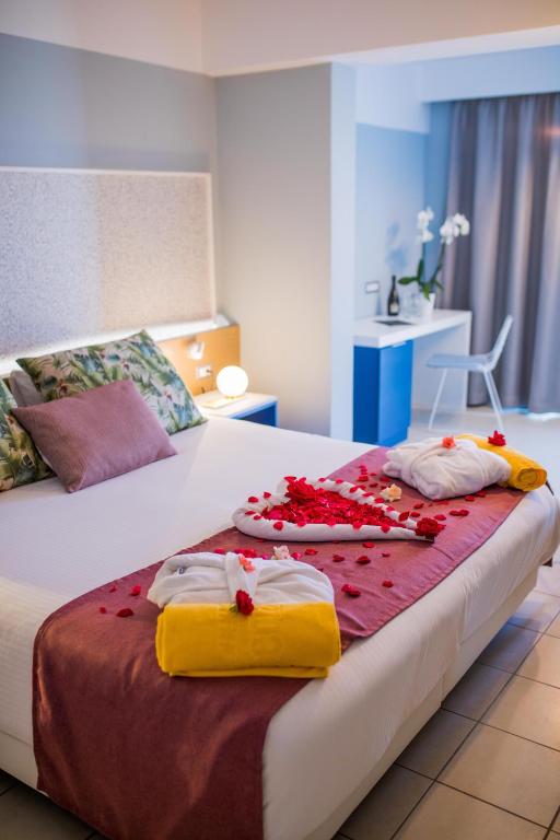 A bed or beds in a room at Lindos Breeze Beach Hotel