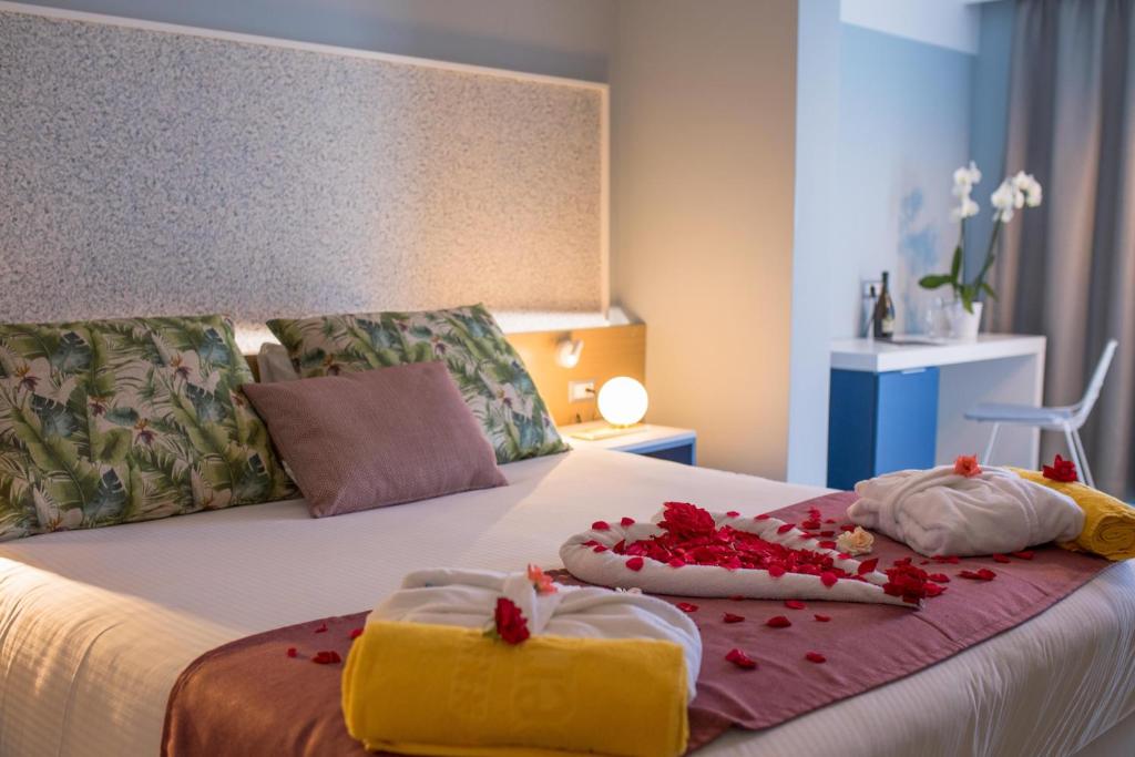 A bed or beds in a room at Lindos Breeze Beach Hotel