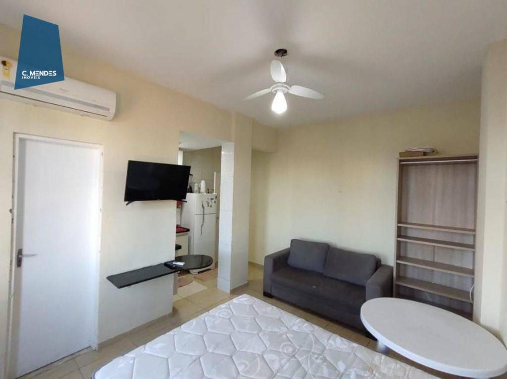a living room with a couch and a ceiling fan at Apartamento in Fortaleza