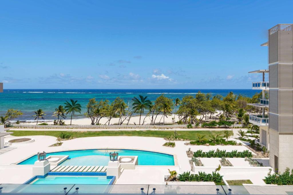 an aerial view of a resort with a swimming pool and the beach at Wyndham Grand Barbados Sam Lords Castle All Inclusive Resort in Saint Philip