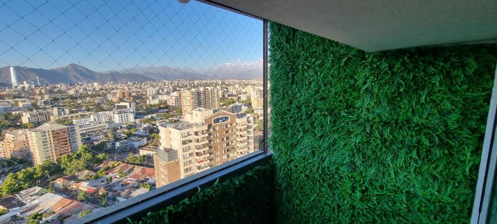 a room with a wall covered in green plants at Hermoso y acogedor Apartamento in Santiago