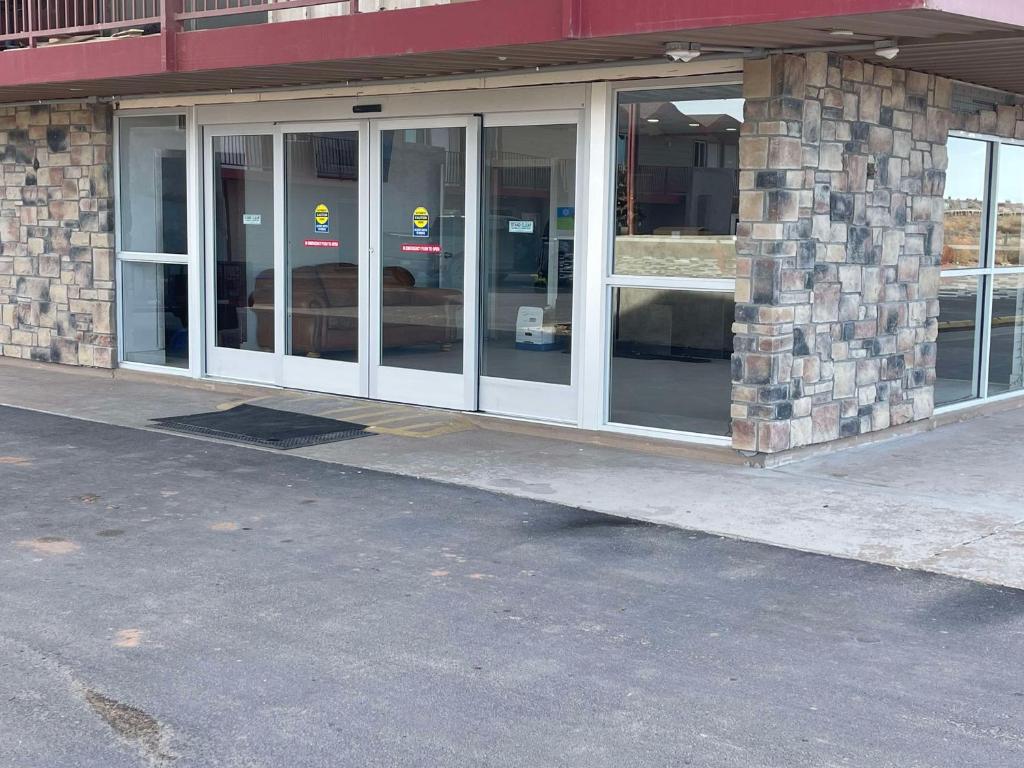 a store front with glass windows on a street at SureStay by Best Western Chambers Petrified Forest in Chambers
