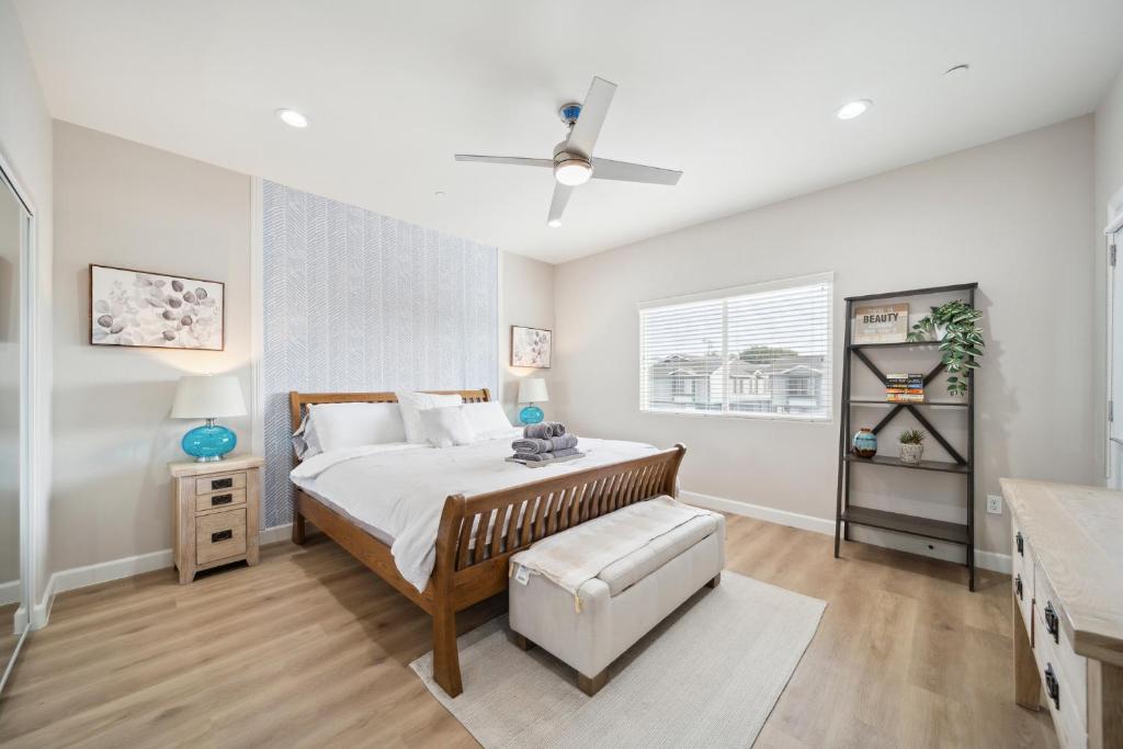 a bedroom with a bed and a ceiling fan at Amazing Value with High Comfort, 14 Guests for 4BR by Disneyland, Beaches, Rodeo 39 & More in Midway City