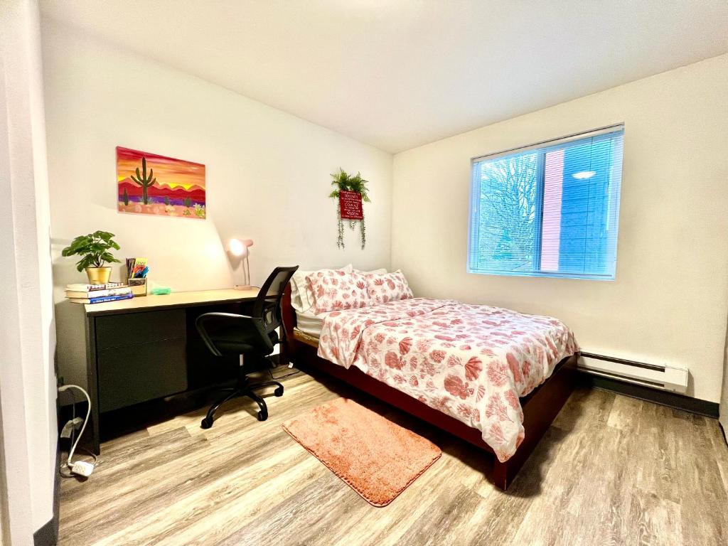 Schlafzimmer mit einem Bett, einem Schreibtisch und einem Computer in der Unterkunft Apartment Studio 10 minutes walk to University of Washington in Seattle