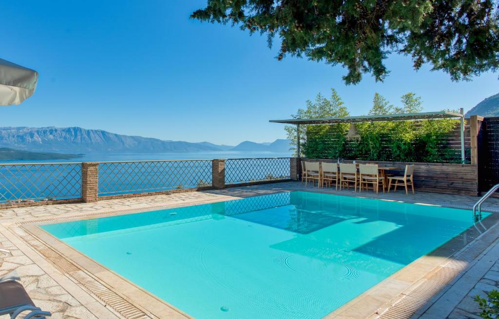 a swimming pool with a view of the water at Diodati Villas in Nikiana