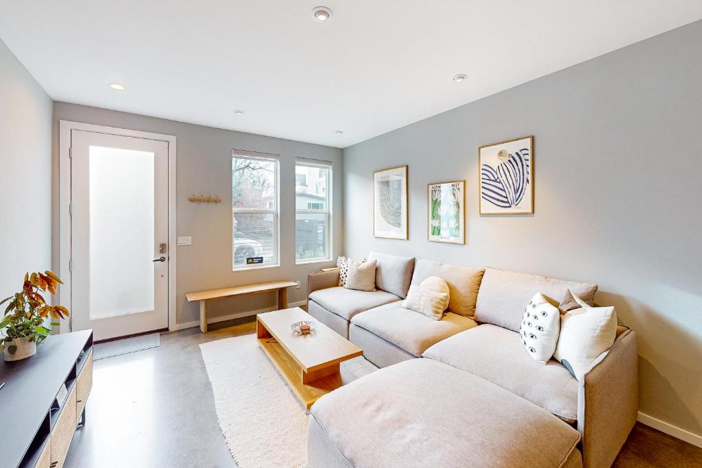 a living room with a couch and a table at Luxury Ballard Townhome in Seattle