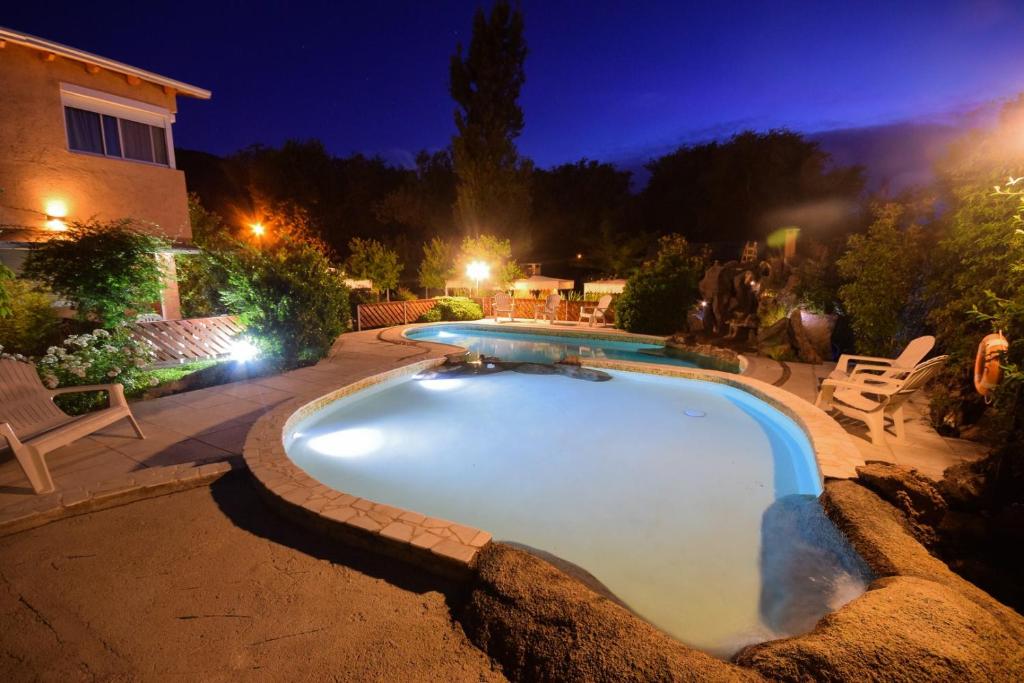 a swimming pool in a yard at night at complejo miligamapa con piscina climatizada in Villa Carlos Paz