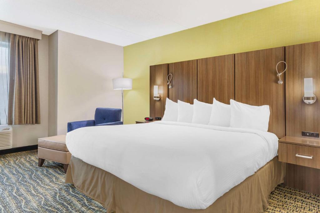 a large white bed in a hotel room at Best Western Plus New Englander in Woburn