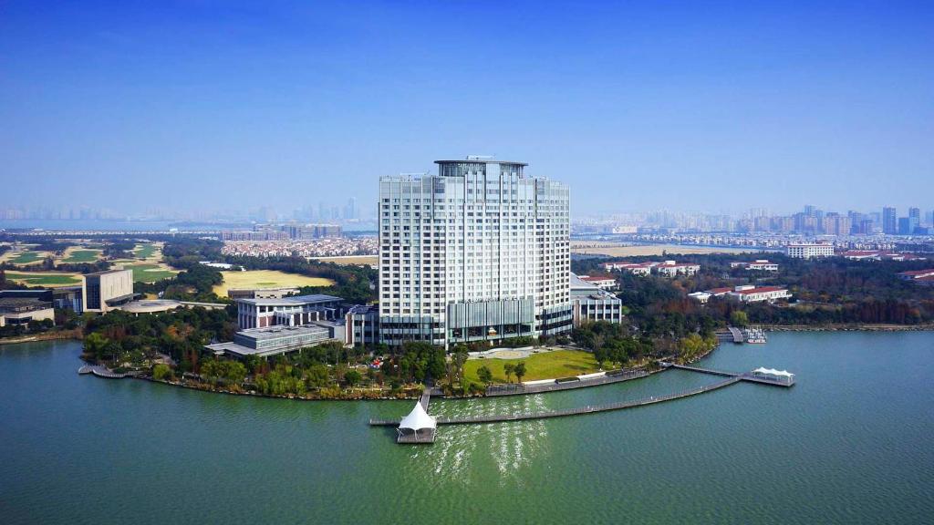 an aerial view of a large building on a river at Kempinski Hotel Suzhou in Suzhou
