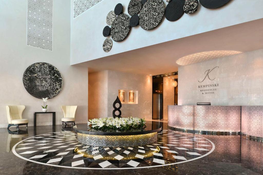 a lobby with a fountain in the center of a building at Kempinski Residences & Suites, Doha in Doha