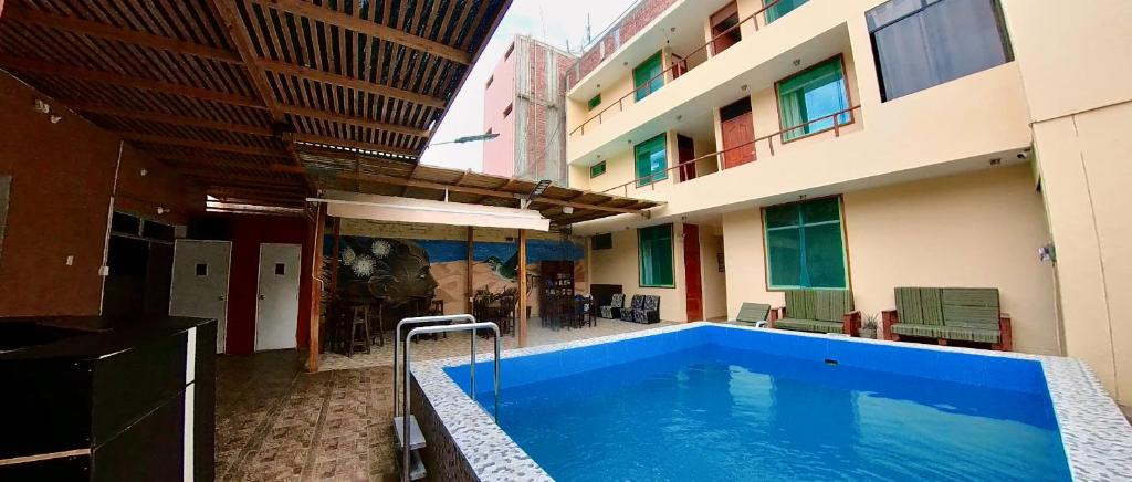 a swimming pool in the middle of a building at El Boulevard de Huacachina in Ica