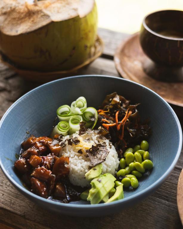 a blue bowl of food with rice and peas at Captain Coconuts Gili Air in Gili Air