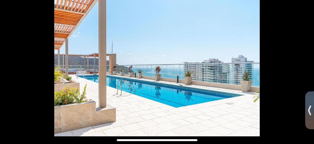 a swimming pool on the roof of a building at Salguero suites resort apartamento in Gaira