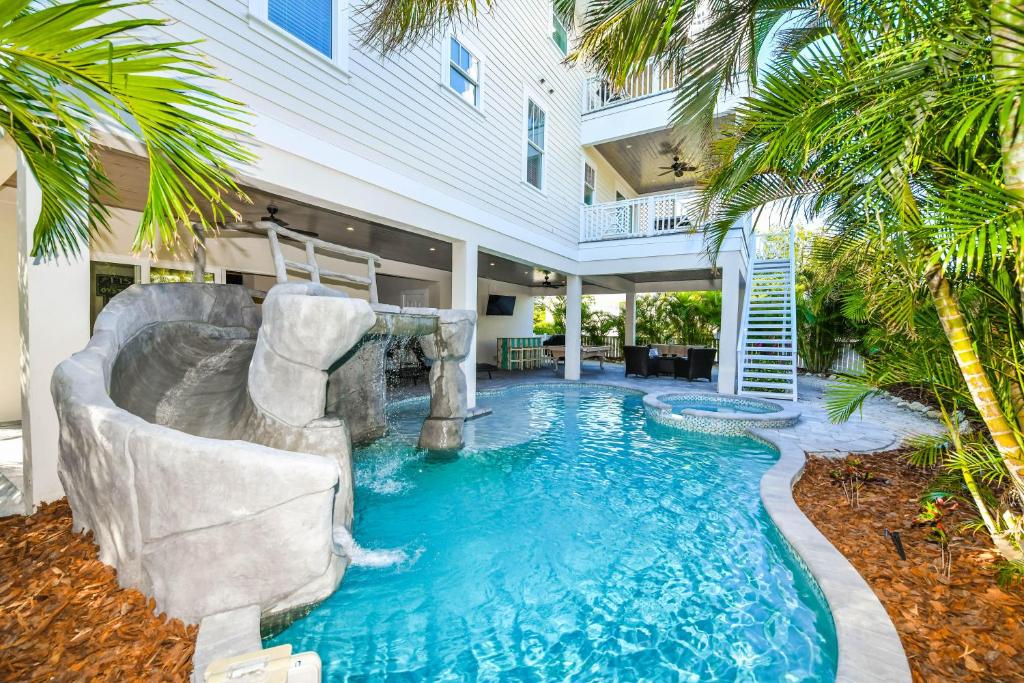 uma piscina com escorrega numa casa em Atlantis Beach House em Bradenton Beach