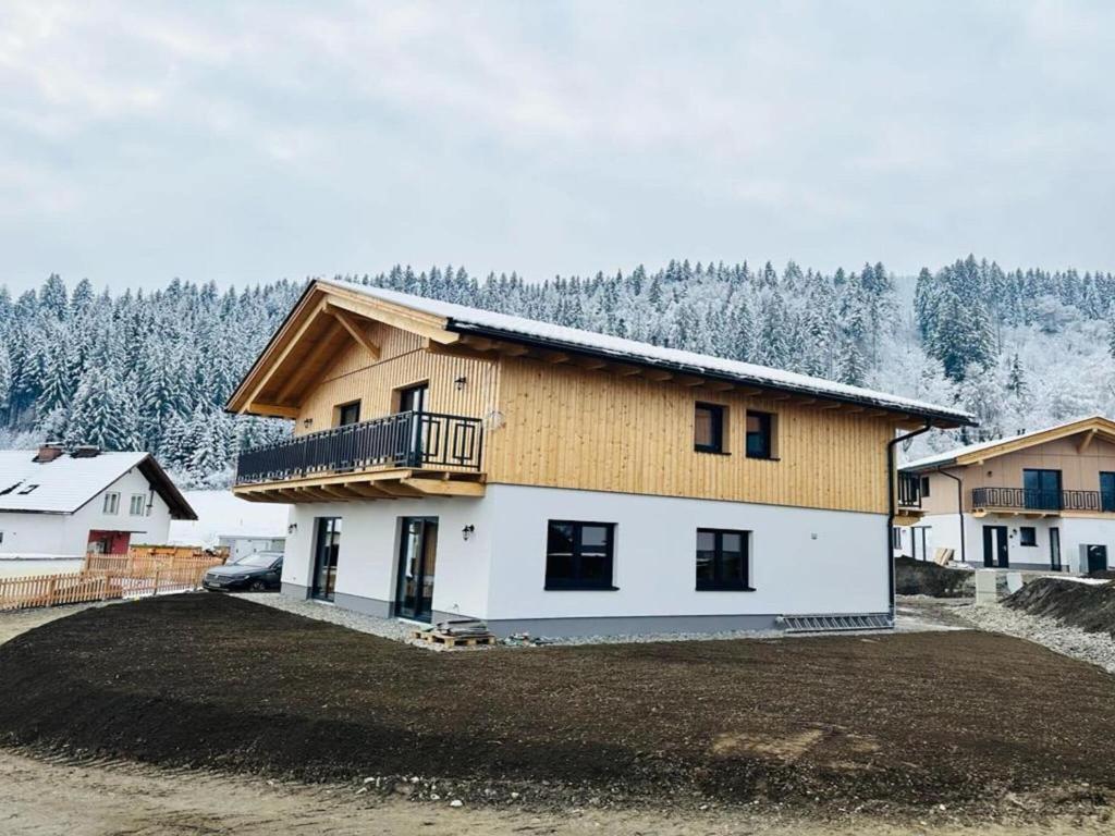 uma casa com uma varanda ao lado em Chalet near Lake Pressegger and Nassfeld ski area em Hermagor