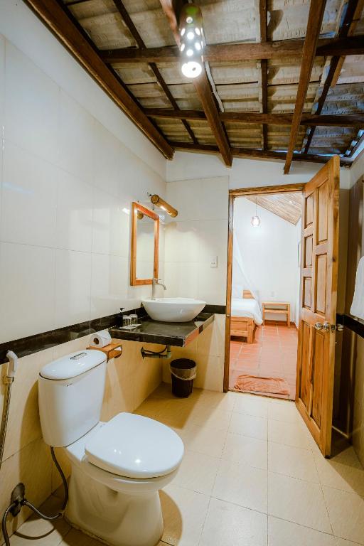 a bathroom with a toilet and a sink at La Mer Resort, Phú Quốc in Phú Quốc