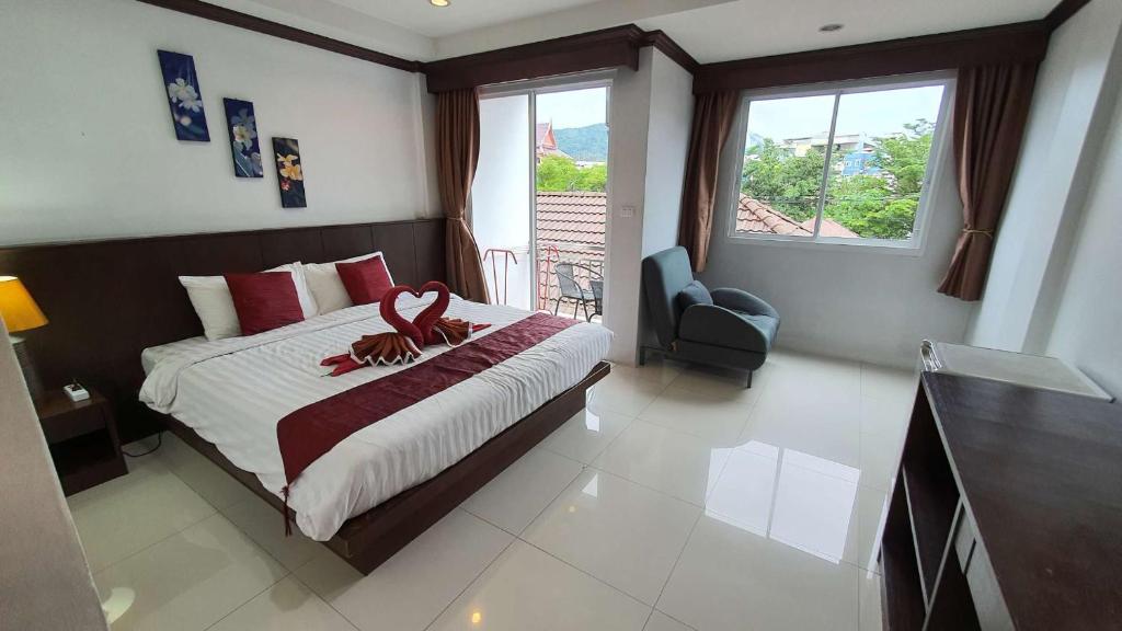 ein Schlafzimmer mit einem Bett, auf dem ein Stofftier liegt in der Unterkunft 水果天堂旅馆Fruit Paradise in Patong Beach