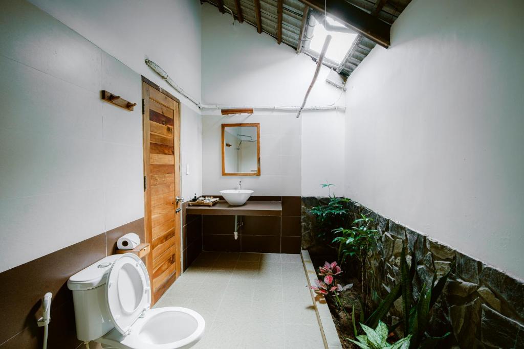 a bathroom with a sink and a toilet in it at La Mer Resort, Phú Quốc in Phú Quốc