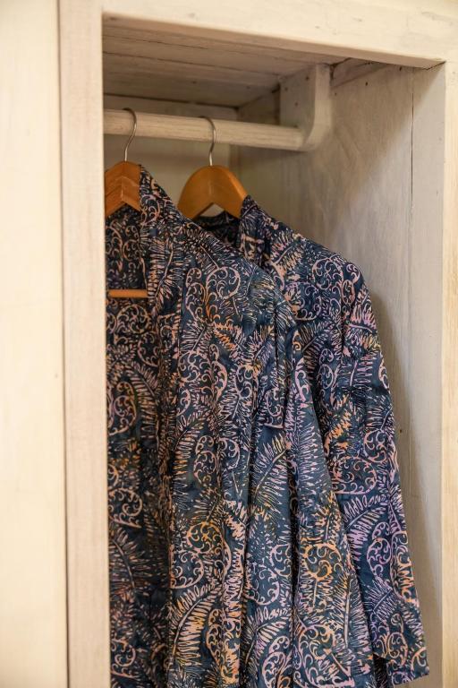 a shirt hanging on a rack in a closet at Captain Coconuts Gili Air in Gili Air