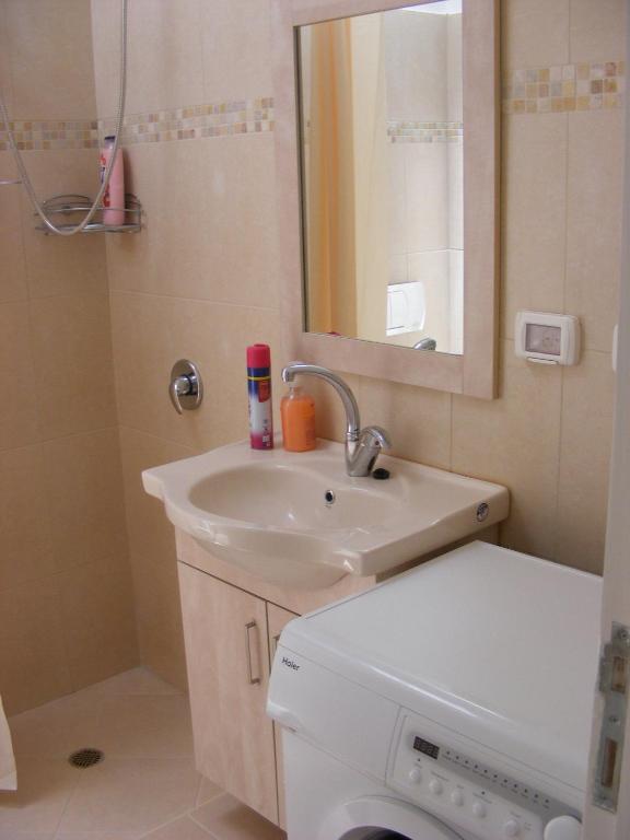 a bathroom with a sink and a toilet and a mirror at Nof Canaan in Kfar Adumim