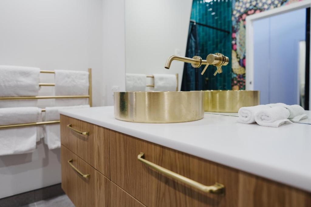 a bathroom with a sink and a mirror at The Chamberson in Dunedin