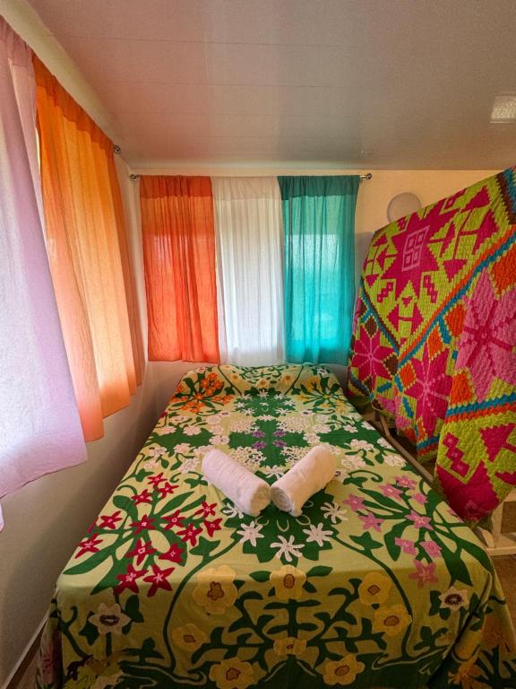 ein Schlafzimmer mit einem Bett mit zwei Handtüchern darauf in der Unterkunft Toamanahere Guesthouse in Tubuai