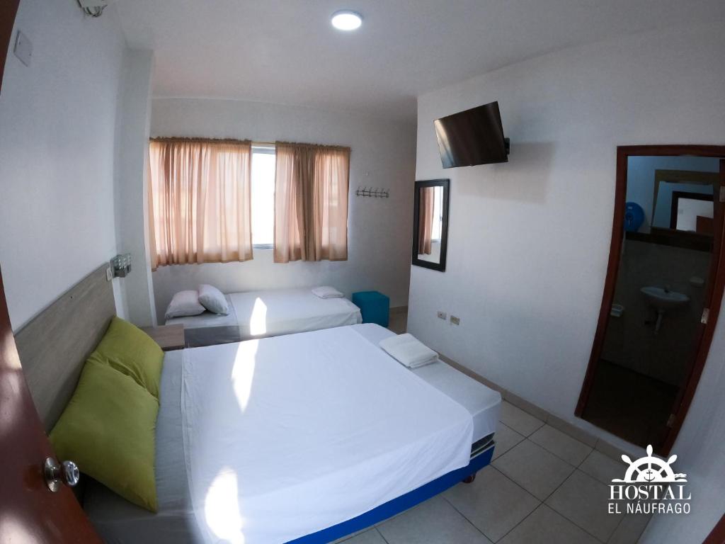 Postel nebo postele na pokoji v ubytování Hostal El Naufrago 1