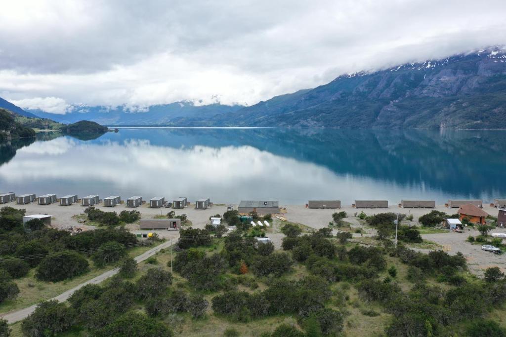 a view of a lake with mountains in the background at Chelenko Lodge in Puerto Tranquilo