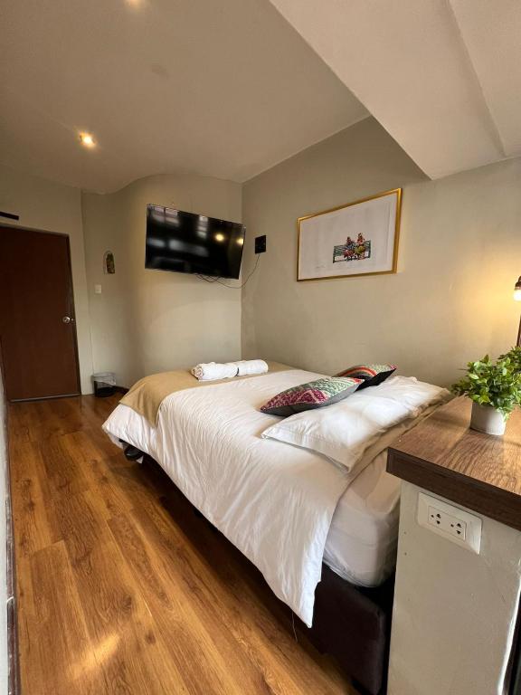 Postel nebo postele na pokoji v ubytování Hostal María Angola