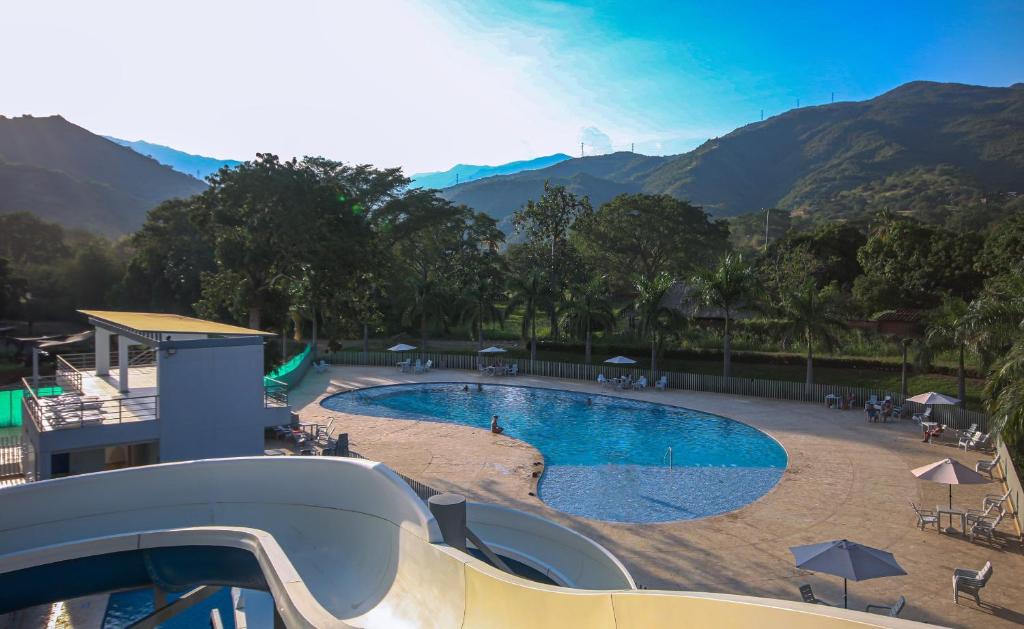 a view of a swimming pool at a resort at Apto Di Sole Santa FeAntioquia in Santa Fe de Antioquia