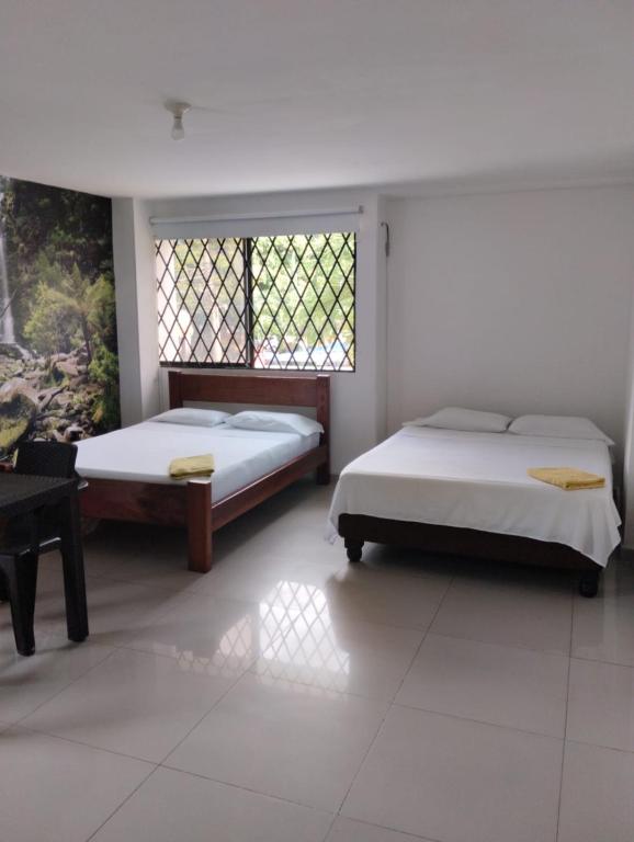 A bed or beds in a room at Apartahotel APR