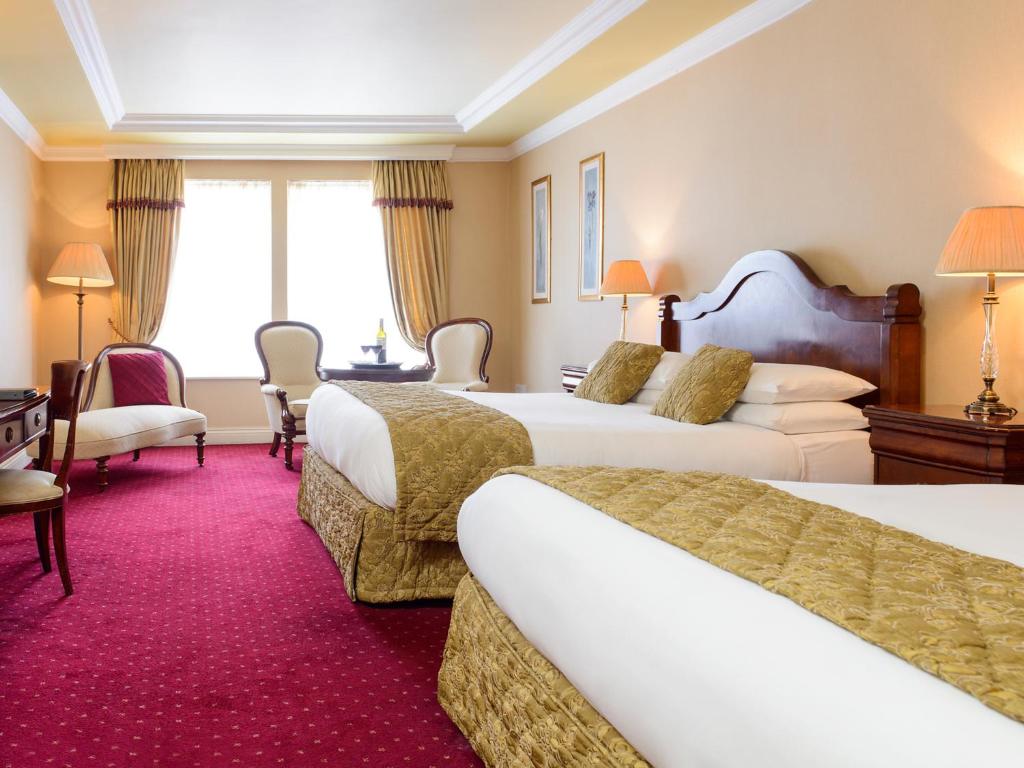 Voodi või voodid majutusasutuse Meadowlands Hotel toas