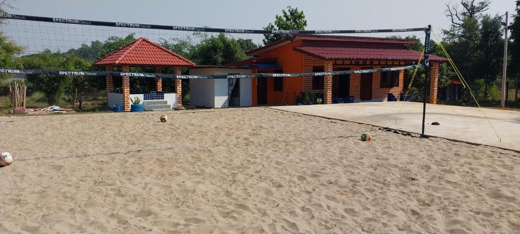 a volleyball court with a volley ball net in the sand at Scorpion Wings Eco-Resort in Ban Na Nga