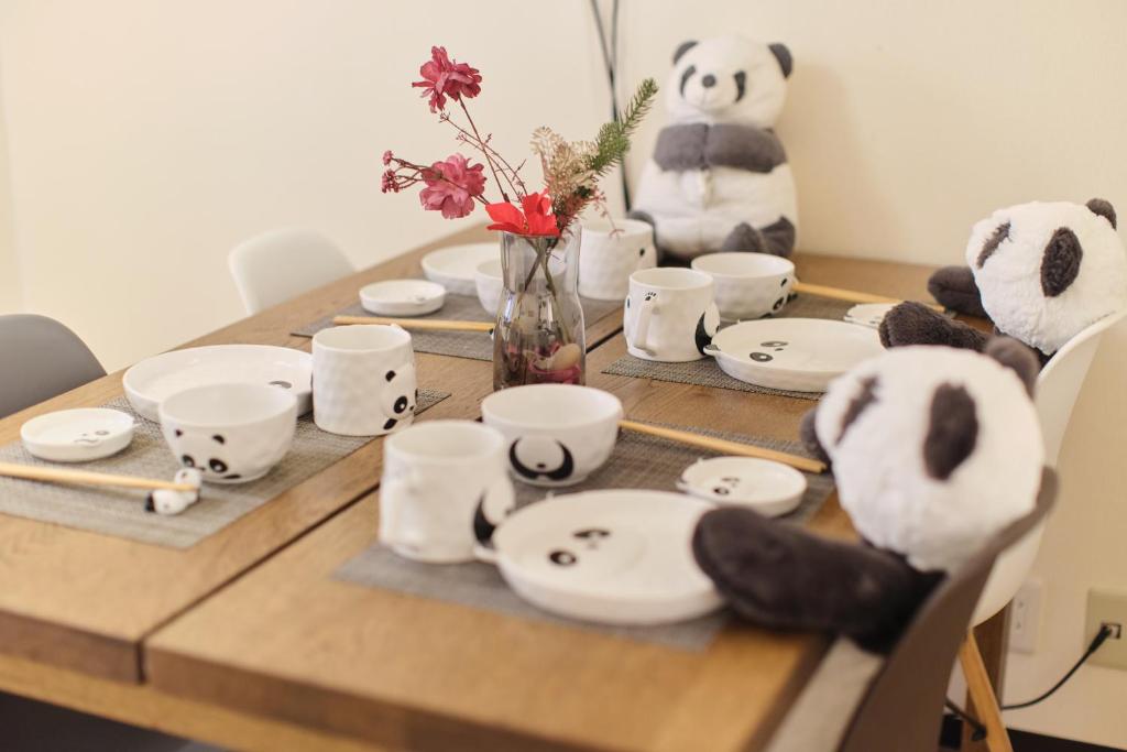 a table with cups and panda bears on it at TORA HOTEL Tokyo Ueno 寅ホテル 上野 B in Tokyo