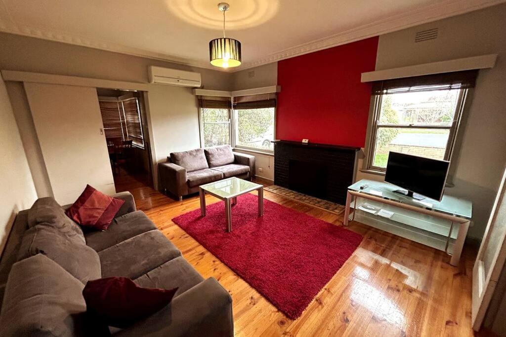 a living room with a couch and a table at Maryborough Central Home in Maryborough