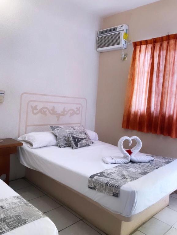 Postel nebo postele na pokoji v ubytování Hotel El almirante