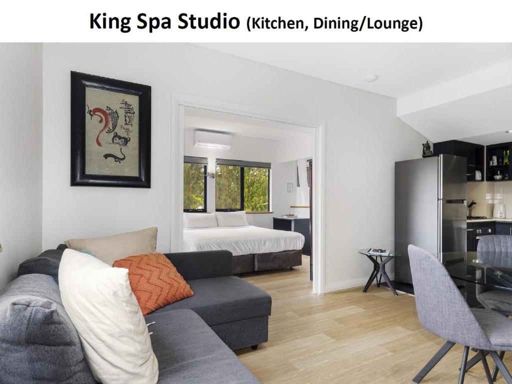 a living room with a couch and a bedroom at Dunsborough Apartments & Suites in Dunsborough