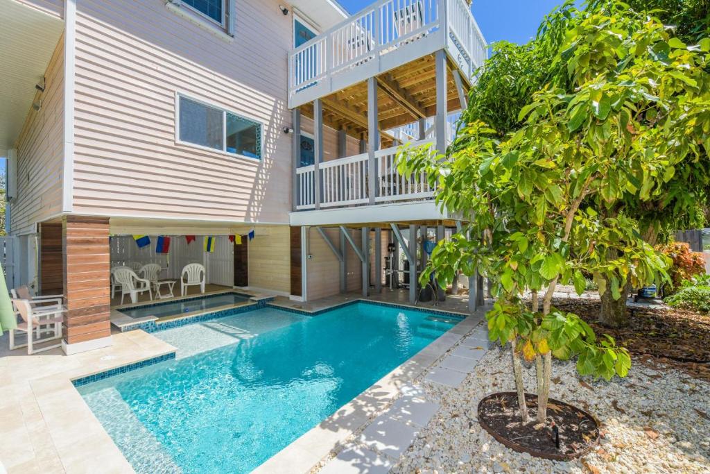 une maison avec une piscine en face d'une maison dans l'établissement The Deckhouse, à Anna Maria