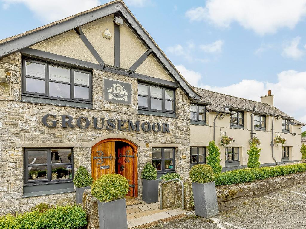 a building with a sign on the front of it at The Grousemoor in Llandegla